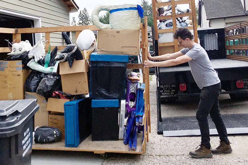 Steve Ackerman loading puppets into my neighbor’s garage for temporary storage